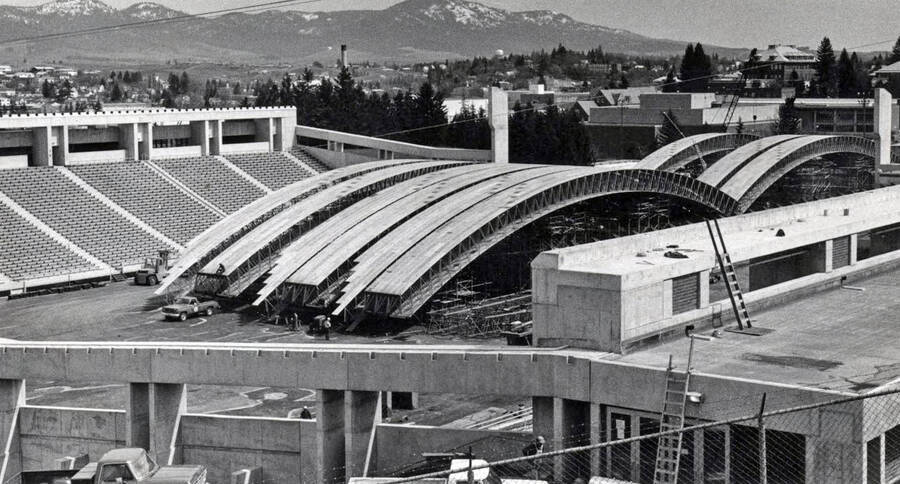 1975 photograph of the Kibbie-ASUI Activity Center under construction. Steam tower in background. Donor: U of I Alumni Office. [PG1_147-27]