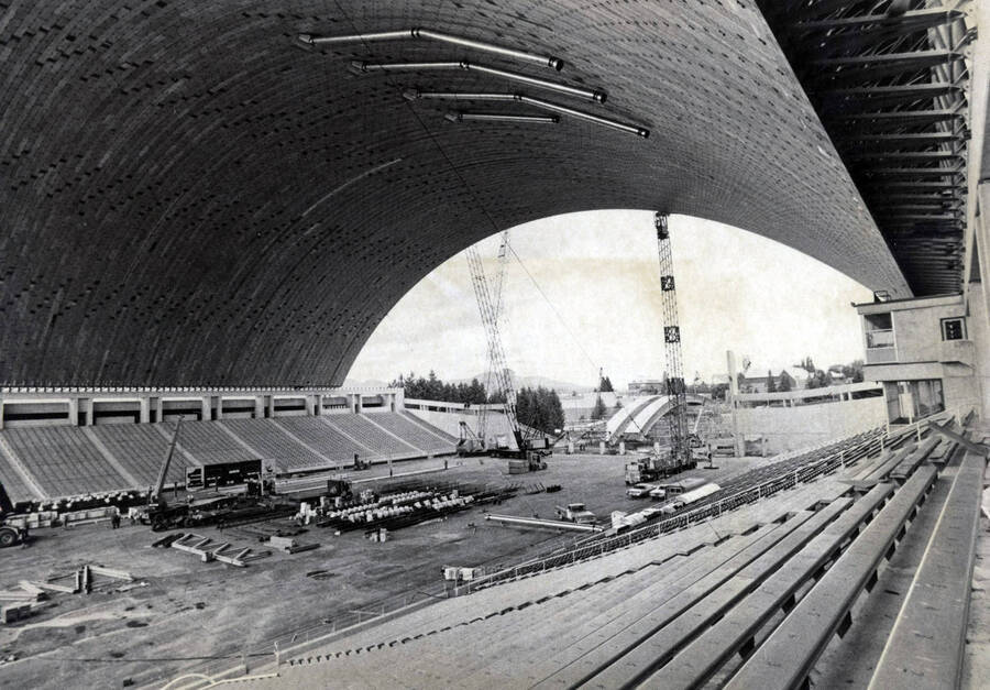 1975 photograph of the Kibbie-ASUI Activity Center under construction. Construction equipment in foreground. Donor: U of I Alumni Office. [PG1_147-31]