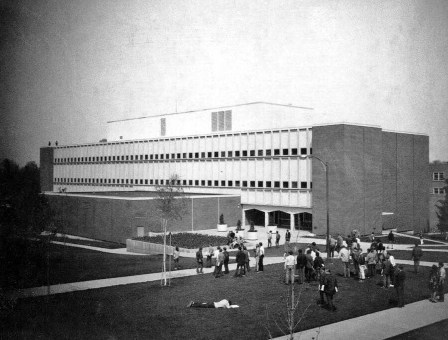 1970 photograph of Renfrew Hall (Physical Science Building). Students in foreground. [PG1_148-04]