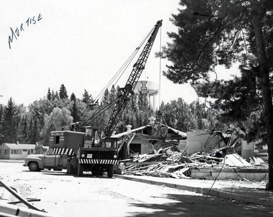 1966 photograph of Temporary Classroom Building #1 under demolition. Water tower in background. Donor: Publications Dept. [PG1_152-03]