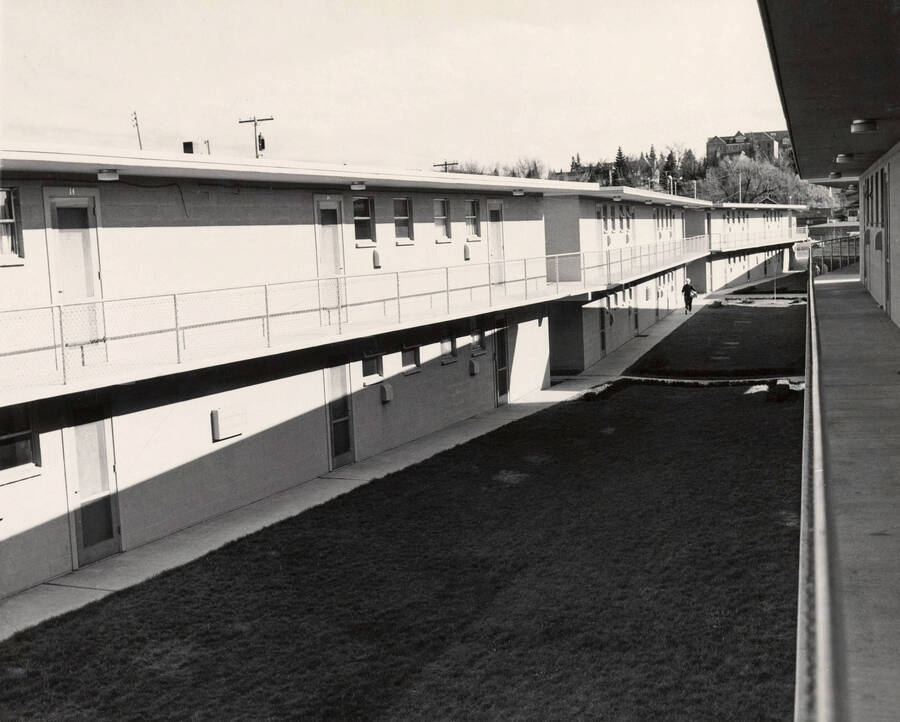 1957 photograph of the Park Village Apartments. Student in background. Donor: Publications Dept. [PG1_154-04]