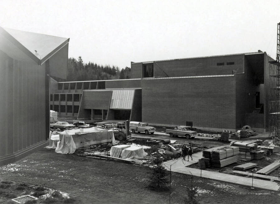 1970 photograph of the Physical Education Building under construction. Students and automobiles in foreground. Donor: Publications Dept. [PG1_157-03]