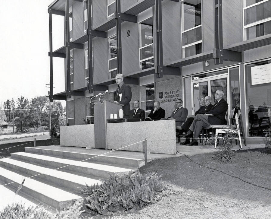 1963 photograph of the Forestry Sciences Laboratory dedication ceremony. Group of men in foreground. Donor: Publications Dept. [PG1_158-02]