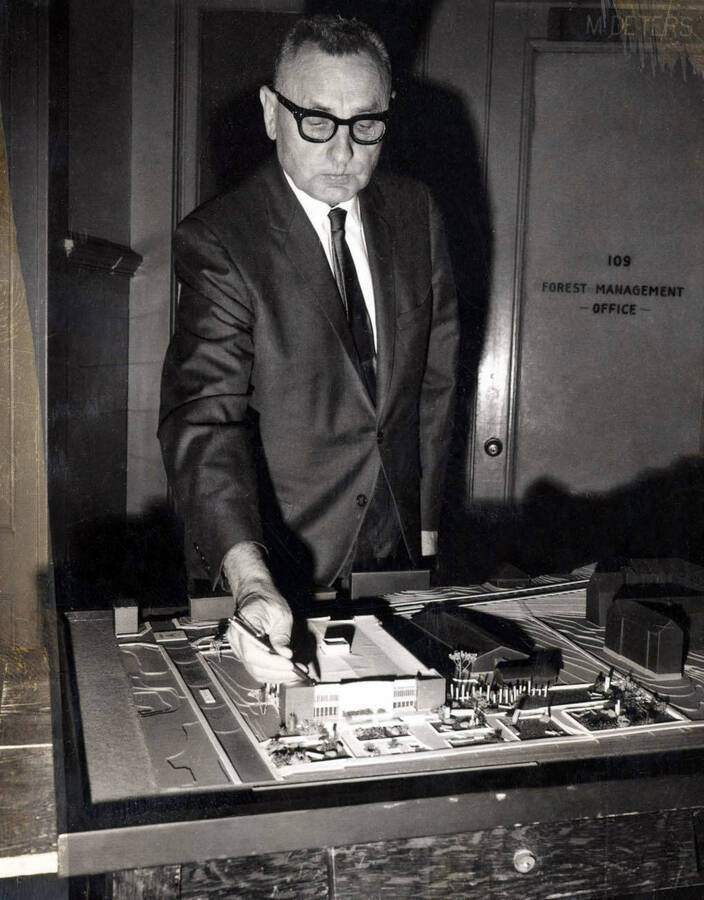 Forestry Building, University of Idaho. Dean Wohletz viewing model of new building. [161-1]