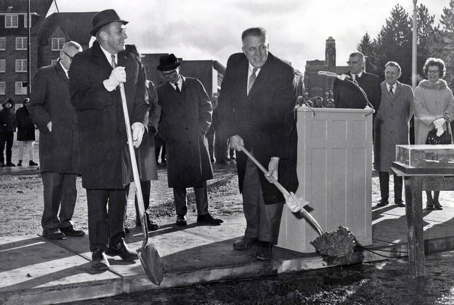 1970 photograph of the Forestry Building groundbreaking ceremony. E.W. Hartung and Don Samuelson in foreground, Memorial Gym in background. [PG1_161-04]