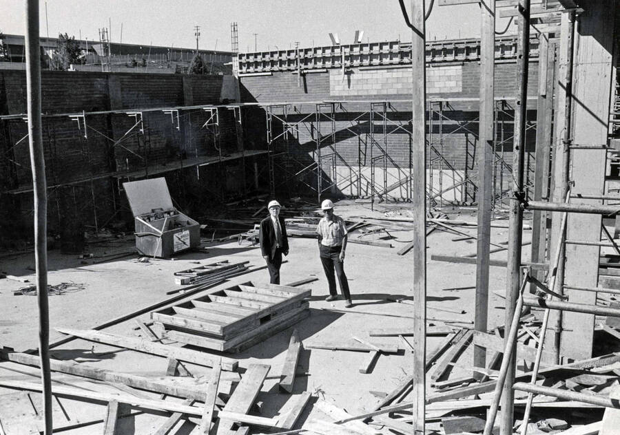 September 15, 1972 photograph of the Menard Law Building under construction. Left to right: A.R. Menard, Dick Benzel inspect the construction site. [PG1_162-13]