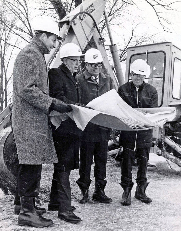 1972 photograph of the Menard Law Building under construction. Left to right: Douglas L. Grant, Albert R. Menard, H. Halverson, George Gagon. [PG1_162-02]