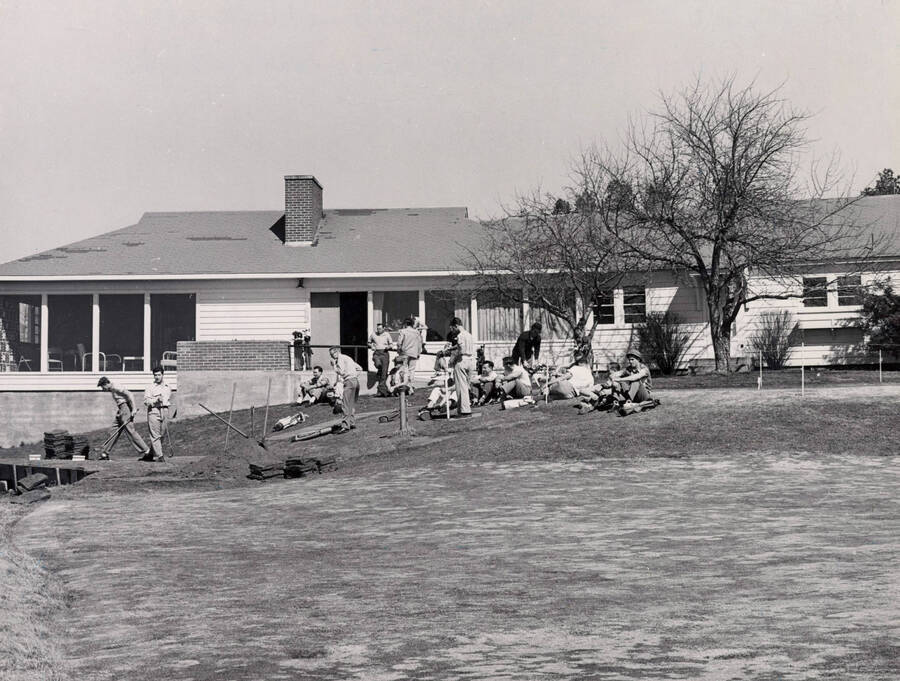 1951 photograph of the James Memorial Clubhouse under construction. A group of men in foreground. [PG1_163-01]