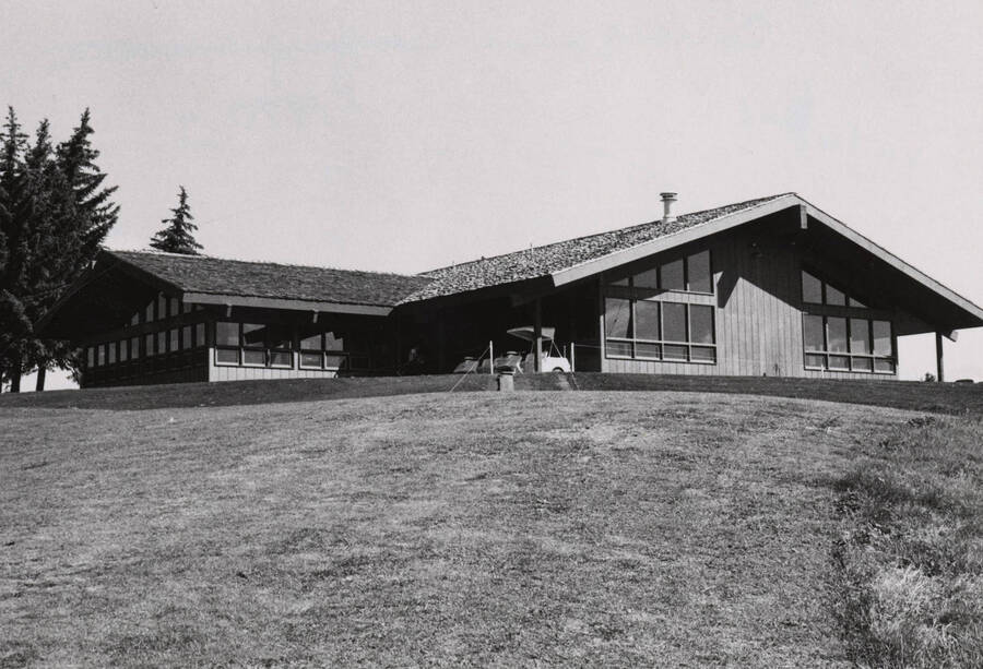 1970 photograph of the ASUI Golf Clubhouse. Golf cart in foreground. [PG1_164-01]