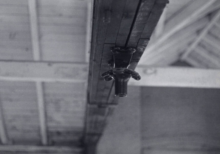 1975 photograph of Art and Architecture South. Detail of old gym hardware on roof beam. Donor: Karl Roenke. [PG1_167-14]