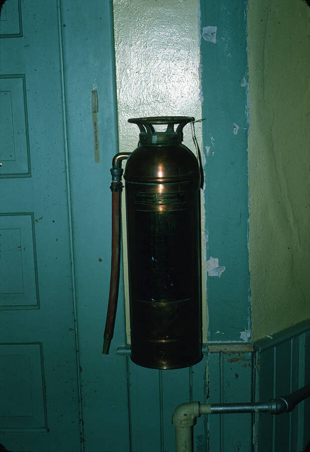 1975 photograph of Art and Architecture South during renovation. Brass fire extinguisher. Donor: Karl Roenke and Robert Weaver, 1976. [PG1_167-070]