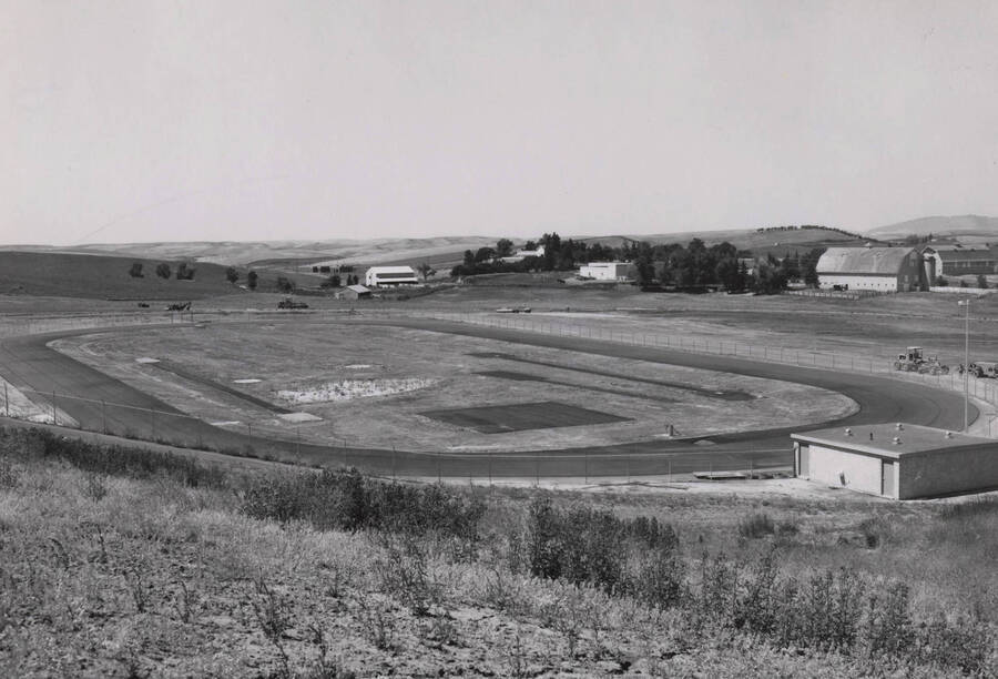 1971 photograph of O'Brien Track and Field Facility. Farm buildings in background. [PG1_168-01]