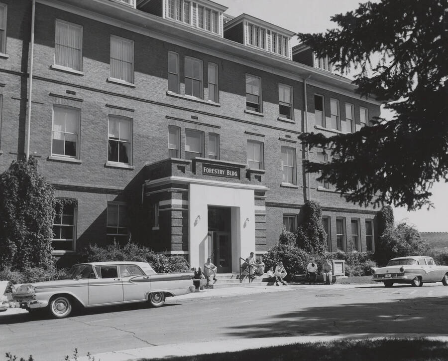 1952 photograph of Forestry Building (Morrill Hall). Students and automobiles in foreground. [PG1_169-05]