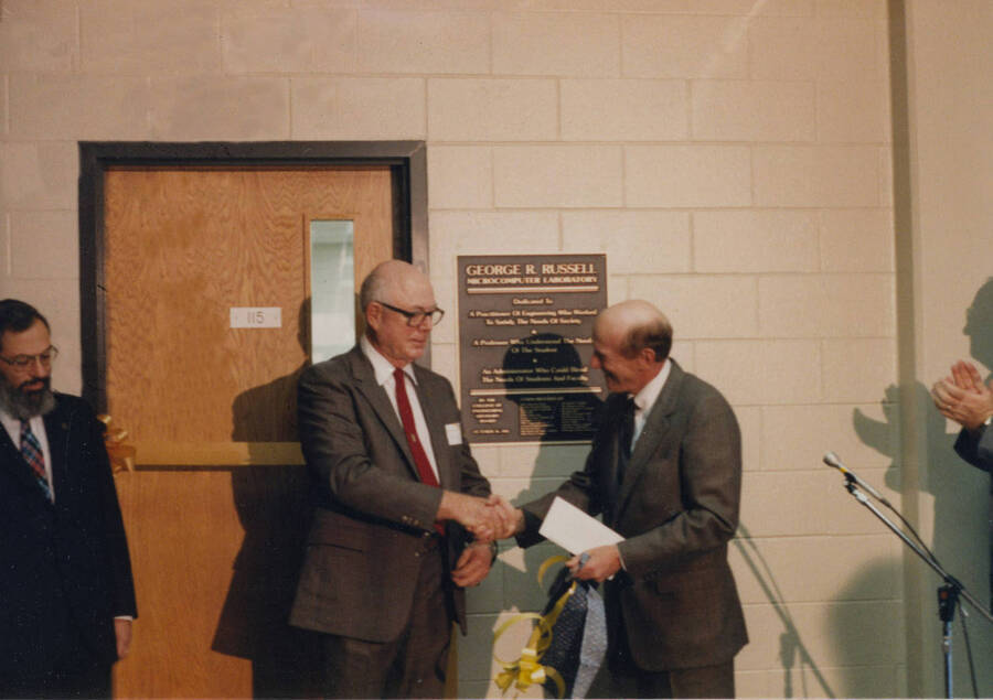 1985 photograph of the George R. Russell Microcomputer Laboratory dedication ceremony. Left to right: Unidentified., G.R. Russell, Richard Gibb. Donor: UI Information, Marythea Grebner. [PG1_172-2]