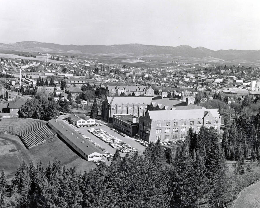 1950 panoramic photograph of University of Idaho campus. The athletic field seating is visible on the left, and a southwest view of the Administration building. [PG1_002-13]
