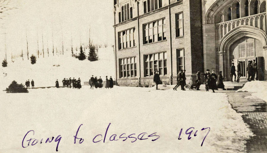 1917 photograph of University of Idaho campus. Students enter the administration Building for classes. Donor: G. Fallquist. [PG1_002-55]