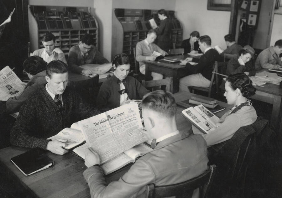 1936 photograph of the Library. Students read periodicals in the reading room. [PG1_201-11]