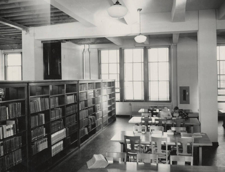 1937 photograph of the Library. Students read in the reading room. [PG1_201-12]