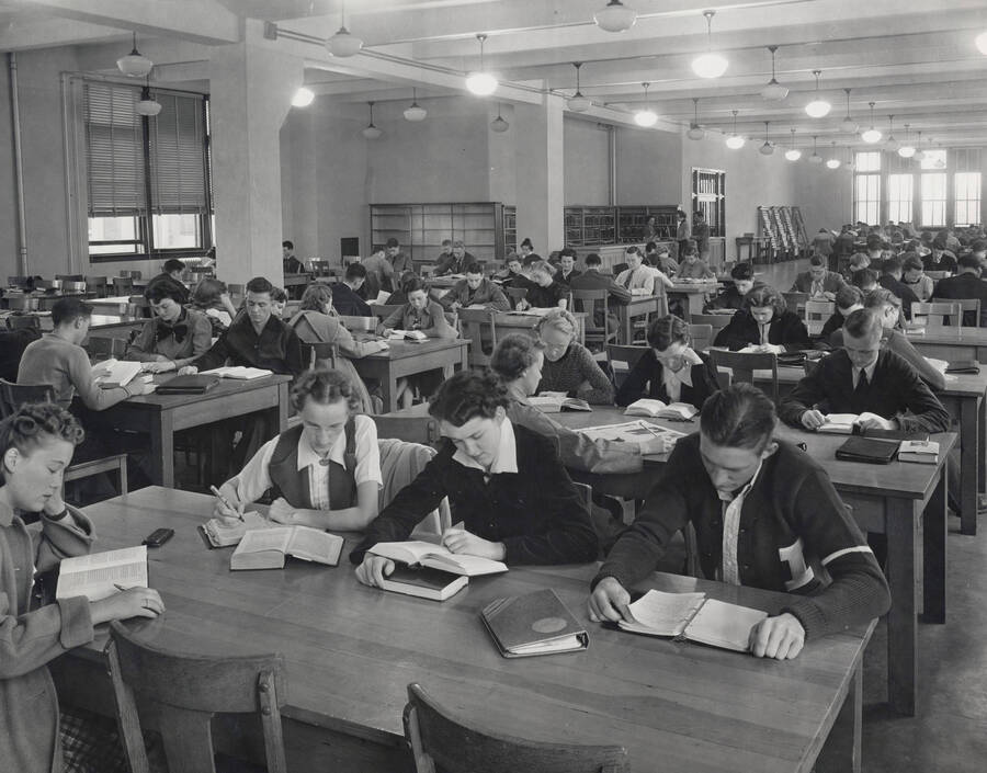 1937 photograph of the Library. Students study in the reading room. [PG1_201-15]