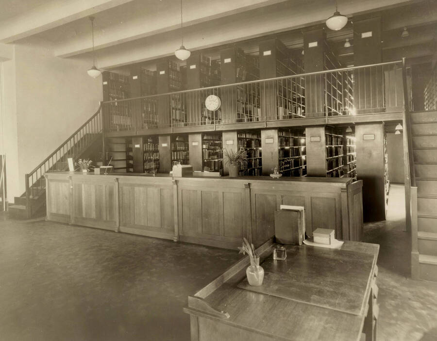 1922 photograph of the Library. Closed stacks behind desk. [PG1_201-05]