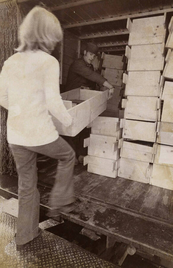 1974 photograph of Law Library. Students transport books to the new library. [PG1_202-11]