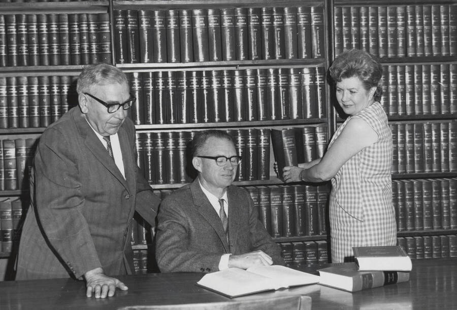 1961 photograph of the Law Library. Left to right: Thomas R. Walenta, George M. Bell, Carolyn Folz. [PG1_202-07]