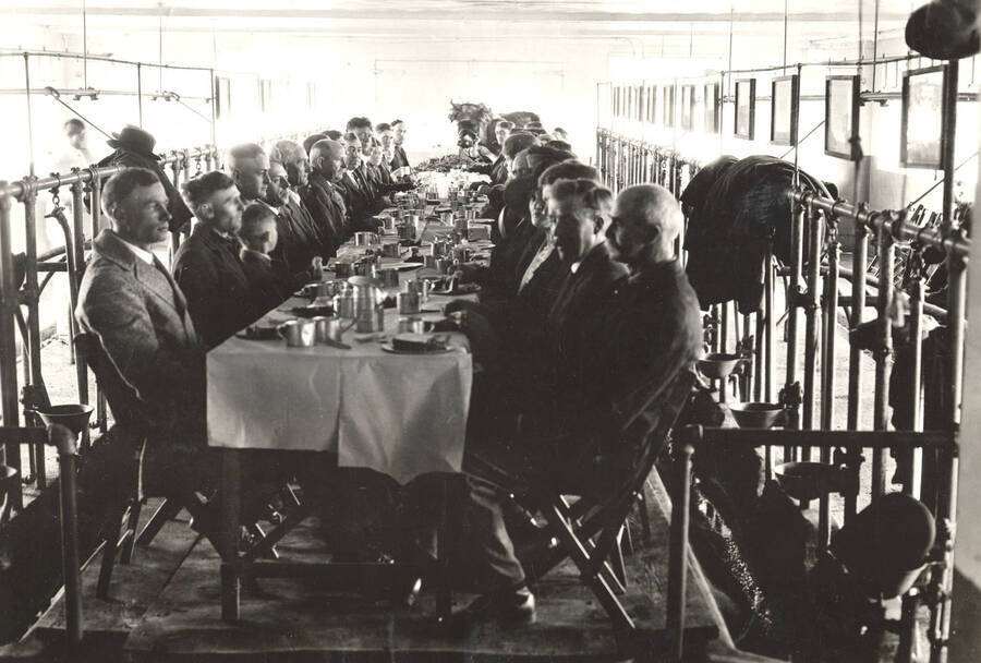 1923 photograph of Dairy Farm and Creamery. Banquet held for Holstein champion Violet Posch Ormsby inside of dairy barn. [PG1_205-13]