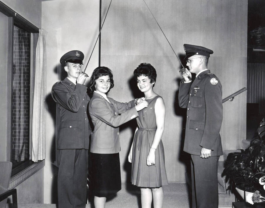 1960 photograph of Military Science Cadets. l-r: Cadet Stanley Russel Fallis, Patsy Mcullough, Margie Irwin, Cadet Garth Eimers. Donor: Army ROTC. [PG1_208-100]