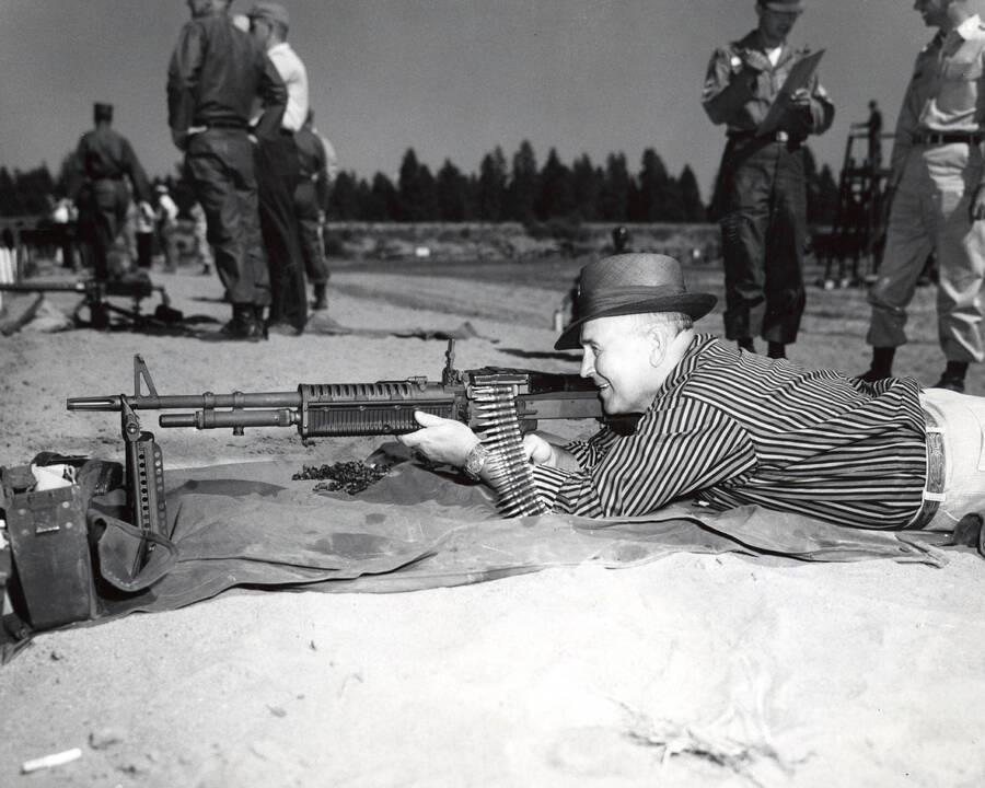 1960 photograph of Military Science Cadets. Guy P. Wicks firing the M-60. Donor: Army ROTC. [PG1_208-110]