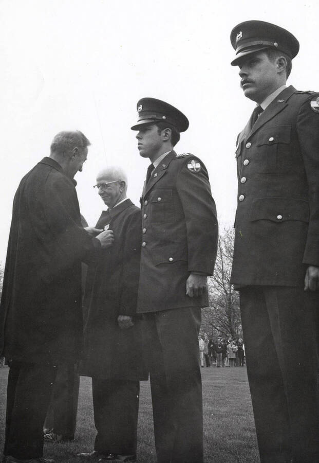 Military Science. University of Idaho. Vice-president H. W. Steffans receives Distinguished Civilian Award from President Hartung at Tri-Service Review. [208-117]