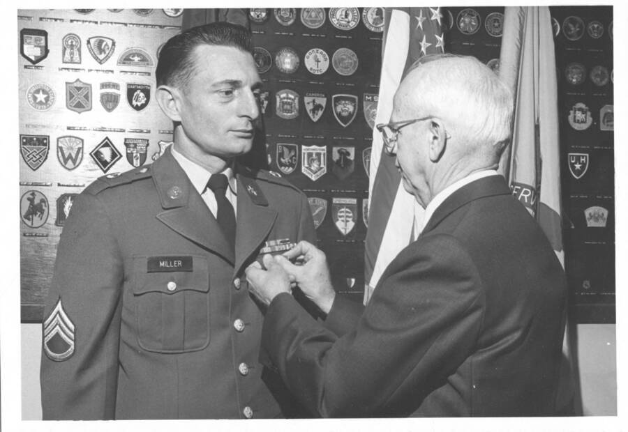 1969 photograph of Military Science Cadets. H. Walter Steffens pins a medal on Staff Sgt. Rodney W Miller. Donor: Publications Dept. [PG1_208-121]
