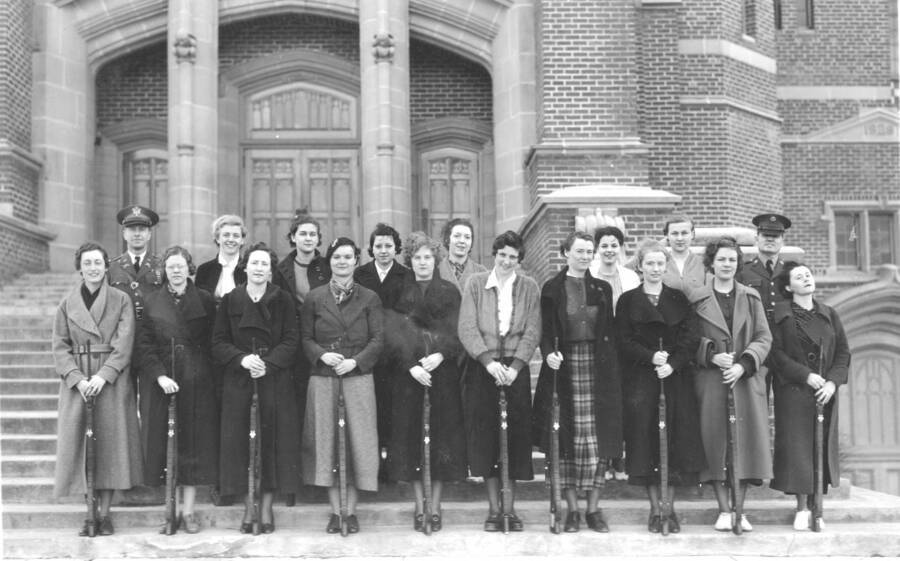 1935 photograph of Military Science Cadets. Women's rifle team standing on the Administration building's steps. Donor: Gerald Hodgins. [PG1_208-139]