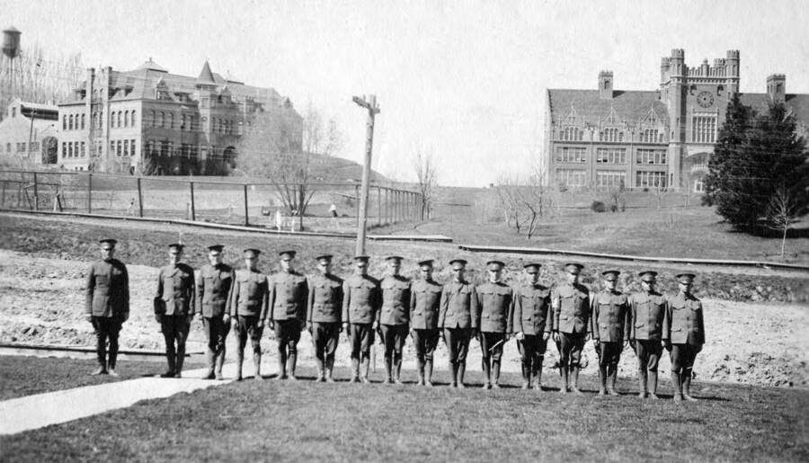 1918 photograph of Military Science Cadets. l-r: F.A. Plastino, F.M. Bistline, A.J. Graf, W. Burnside, unidentified, unidentified, D. Gilchrist, A.G. Wood, K.M. Hunter, E. spiker, unidentified, T. LeClair, unidentified, K. Newland, R. Gochnour. Donor: Emmet Spiker. [PG1_208-150]