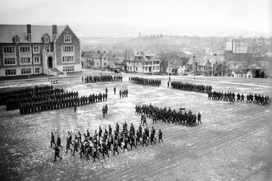 1925 photograph of Military Science Cadets. ROTC regiment in parade formation in front of Science building. [PG1_208-158]