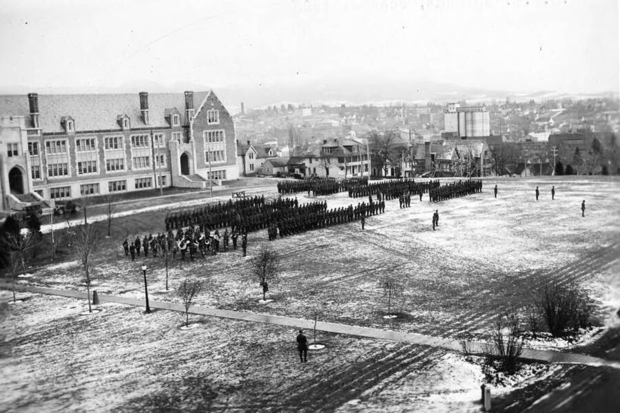 1925 photograph of Military Science Cadets. ROTC regiment in parade formation in front of Science building. [PG1_208-159]