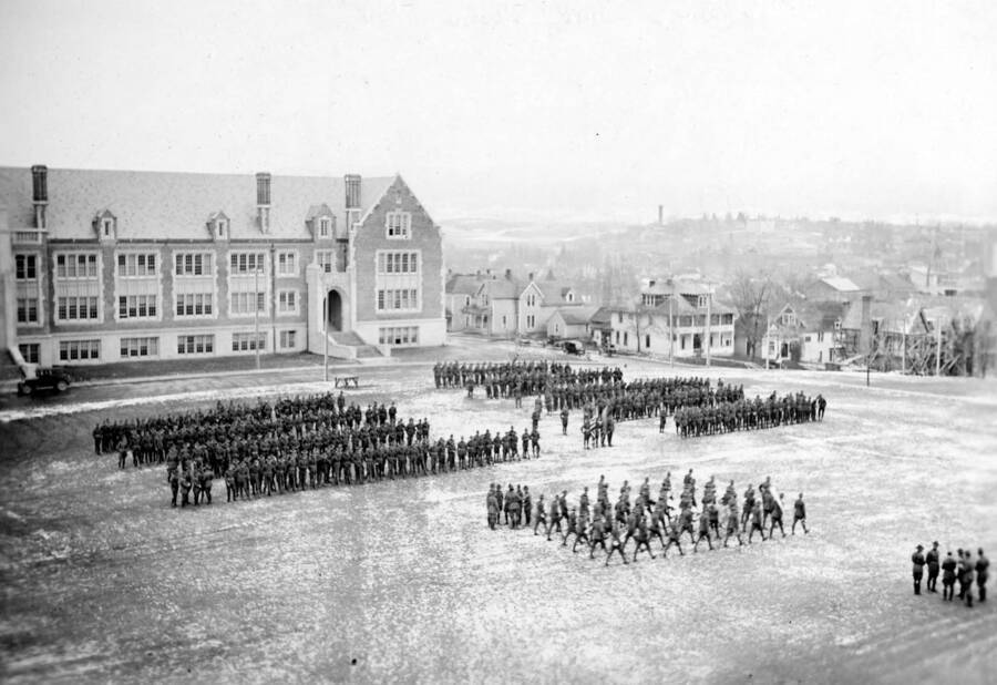 1925 photograph of Military Science Cadets. ROTC regiment in parade formation in front of Science building. [PG1_208-161]
