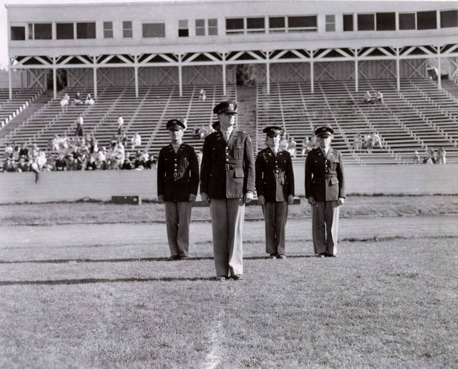 1953 photograph of Military Science Cadets. ROTC regimental staff standing on MacLean field. [PG1_208-165]