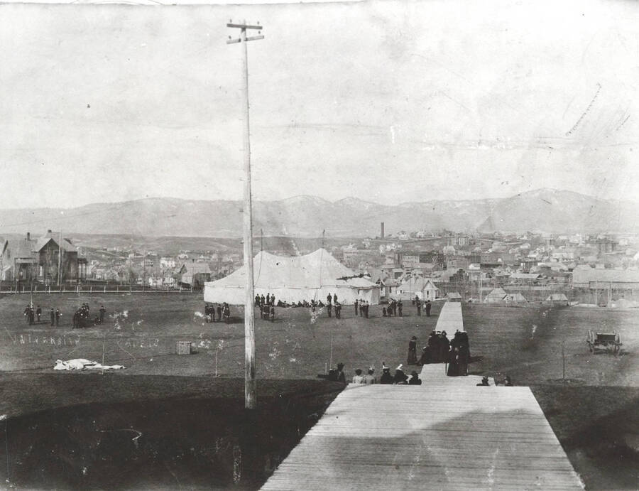 1909 photograph of Military Science Cadets Nitrate negative. Military encampment with campus buildings in the background. [PG1_208-019]