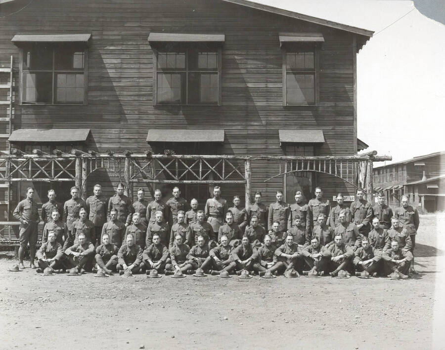 1924 photograph of Military Science Cadets. Cadet officers lined up in front of a building at Camp Lewis. [PG1_208-030]