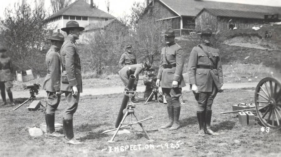 1925 photograph of Military Science Cadets. Military cadets being inspected my a mortar. [PG1_208-031]
