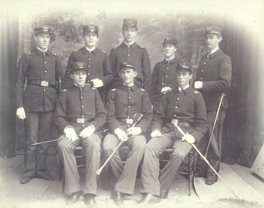 1897 photograph of Military Science Cadets l-r: (front) Charles Armstrong, Gilbert Hogue, George Snow; (back) Harvey Hoagland, Ole Hagberg, William E. Stillinger, Reese Hattabugh, Paul Draper. Donor: Mr. & Mrs. C.R. Stillinger. [PG1_208-004]