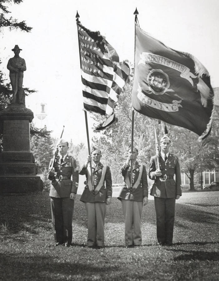 1941 photograph of Military Science Cadets. Color guard at attention at the Spanish-American War Memorial.Idaho and American Flag on display. [PG1_208-047]