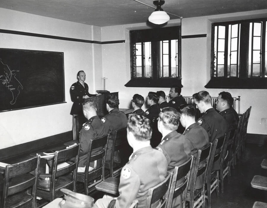 1951 photograph of Military Science Cadets. Military cadets sitting in a classroom during a lecture. [PG1_208-055]