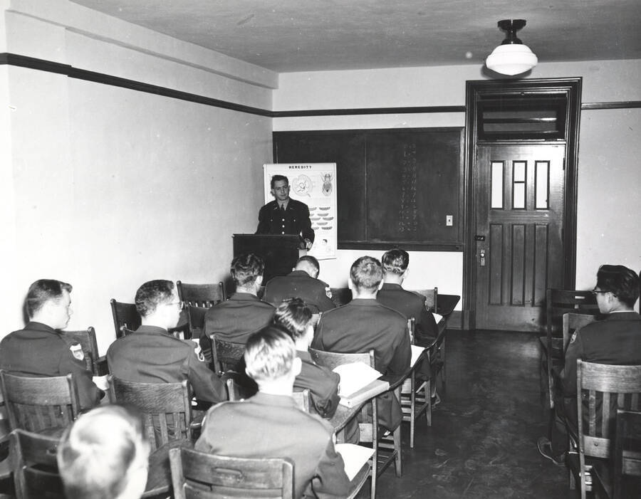 1951 photograph of Military Science Cadets. Military cadets sitting in a classroom during a lecture. [PG1_208-056]