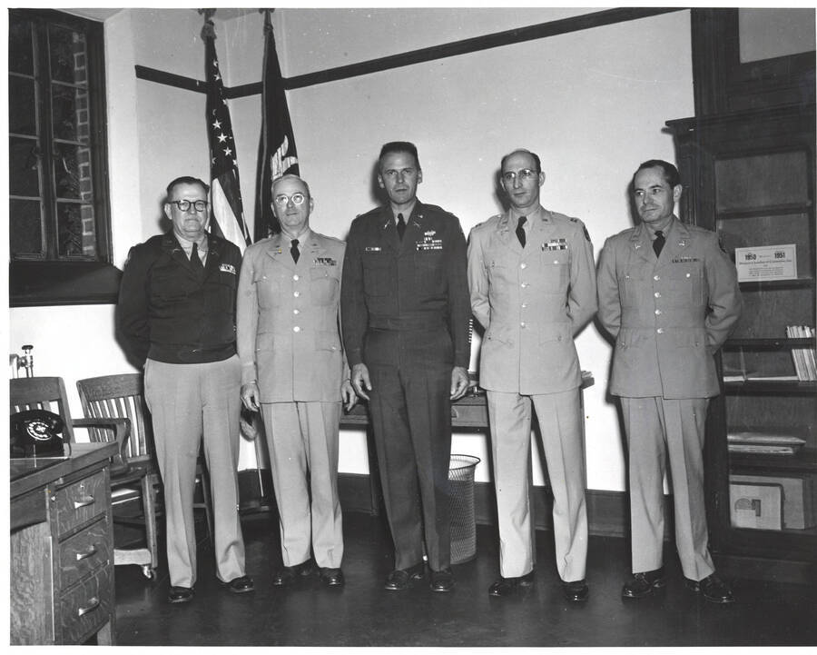 1951 photograph of Military Science Cadets. Inspection team l-r: C.F. Hudson, C.H. Bragg, F.M. Pliniau, D. Tarallo, J.R. George. [PG1_208-057]