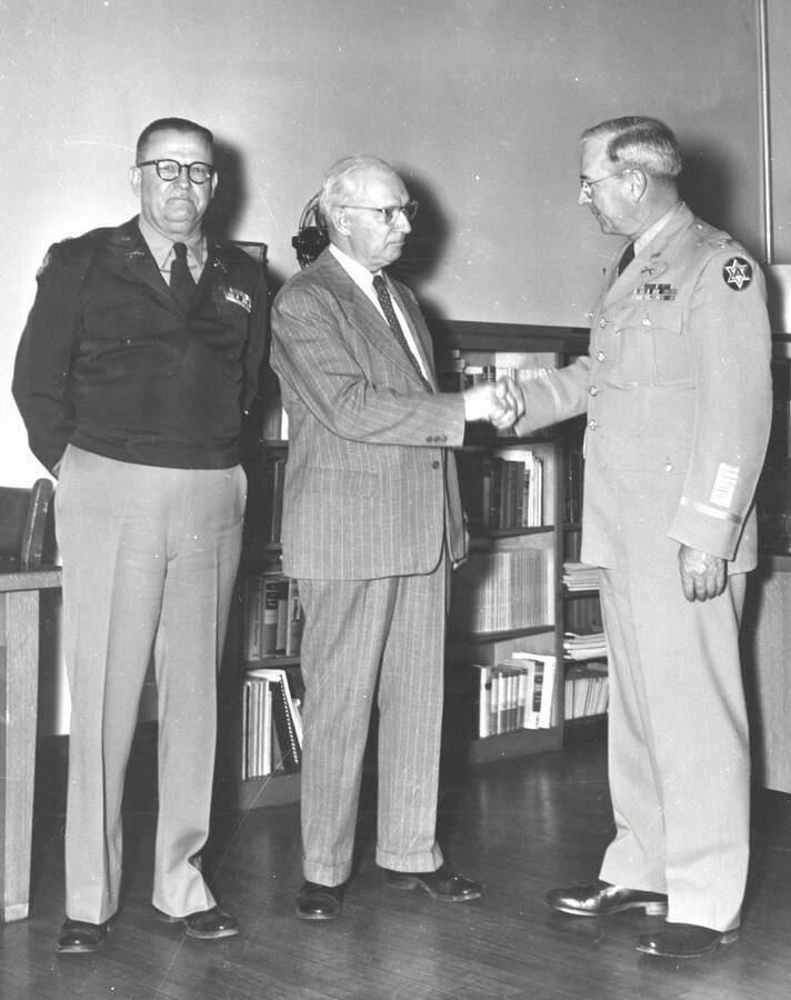 1951 photograph of Military Science Cadets. The inspection team being greeted l-r: C.F. Hudson, T.S. Kerr, C.H. Bragg.. [PG1_208-058]