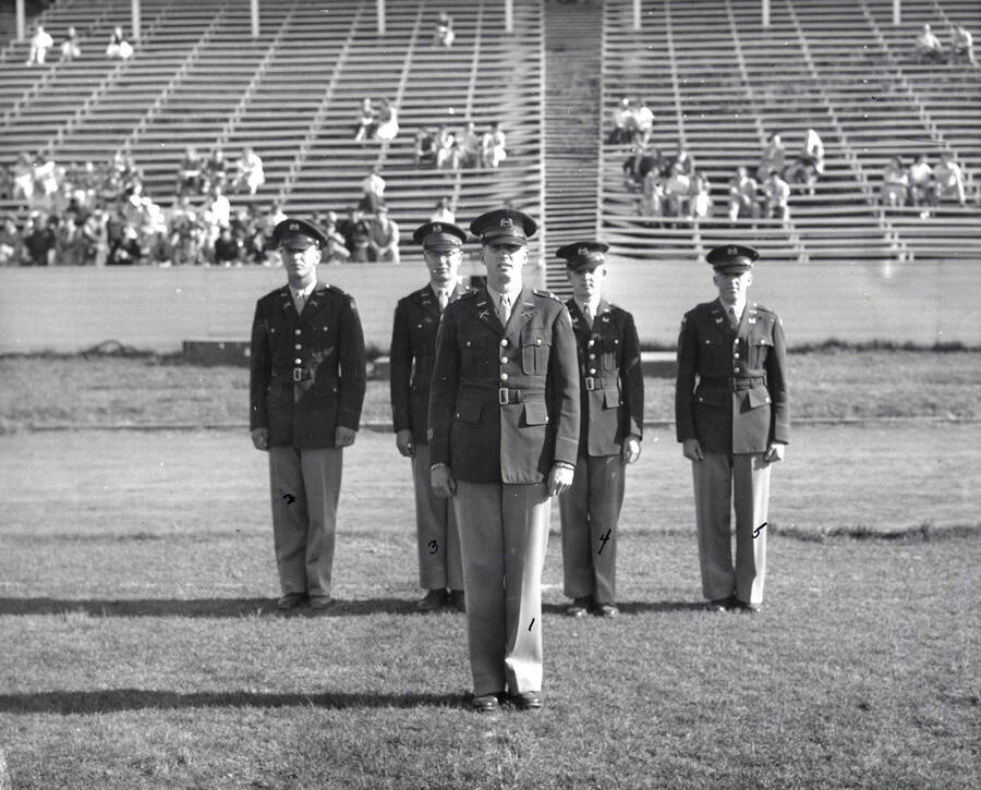 1953 photograph of Military Science Cadets. Regimental staff l-r: Wayne D. Anderson, J.H. Bengston, Peter F. Stickney, F.L. Kopke, Phillip R. Ourada. [PG1_208-063]