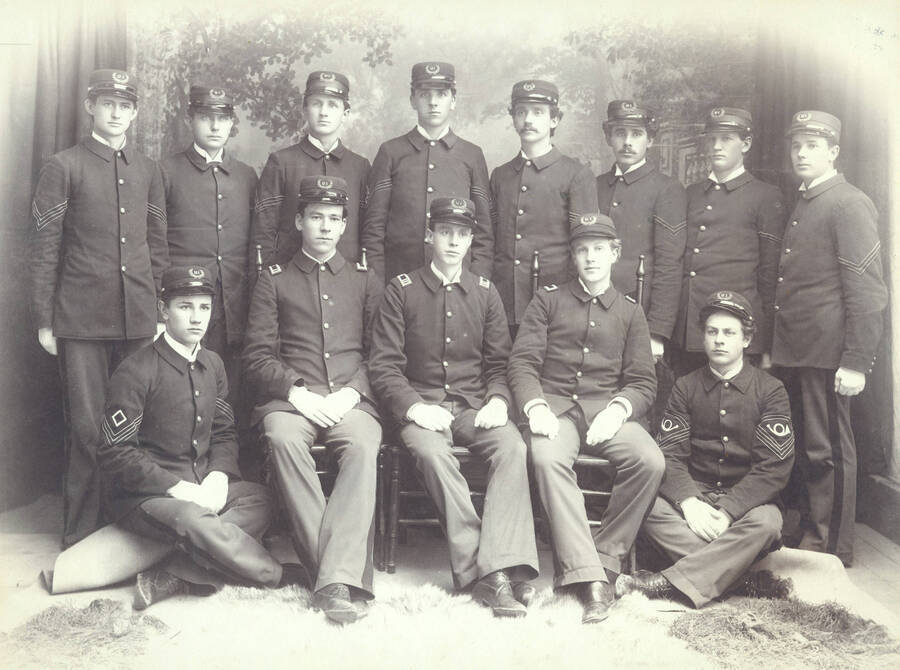 1897 photograph of Military Science Cadets l-r: (front) E. Mautz, W.E. Stillinger, G. Snow, R. Hattabaugh, J. Boyd; (back) J. Burke, J. Herman, B.E. Bush, S. Knudson, M. Reed, H. Estes, J.E. Jewell, E. Armstrong.neg envelope has two negs: one of whole group, one close-up of back row, right side. Portrait of Company 'B' officers. Donor: UofI Army ROTC. [PG1_208-007]