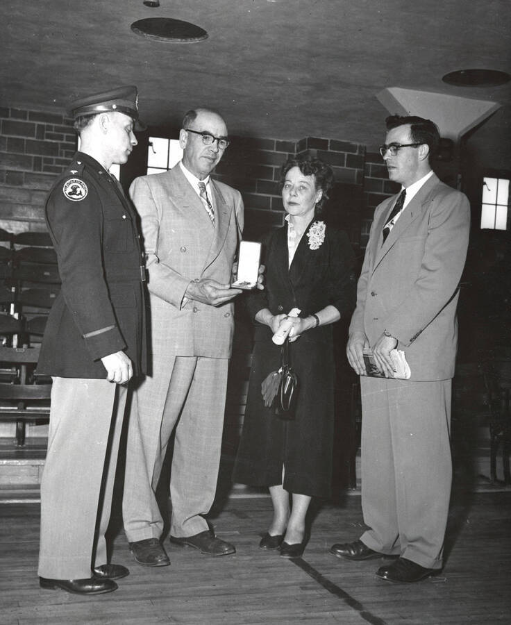 Col. Blewett presenting posthumous Bronze Star in honor of Donald 'Pug' Ellis. Military Science. University of Idaho. [208-86]