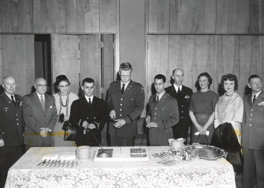 1962 photograph of Military Science Cadets. l-r: Col. James, Pres. Theophilus, Mrs. Thoephilus, Lillico, King, Candray, Capt. Davey, Mrs. Davey, Mrs. Pattison, Col. Pattison. [PG1_208-093]